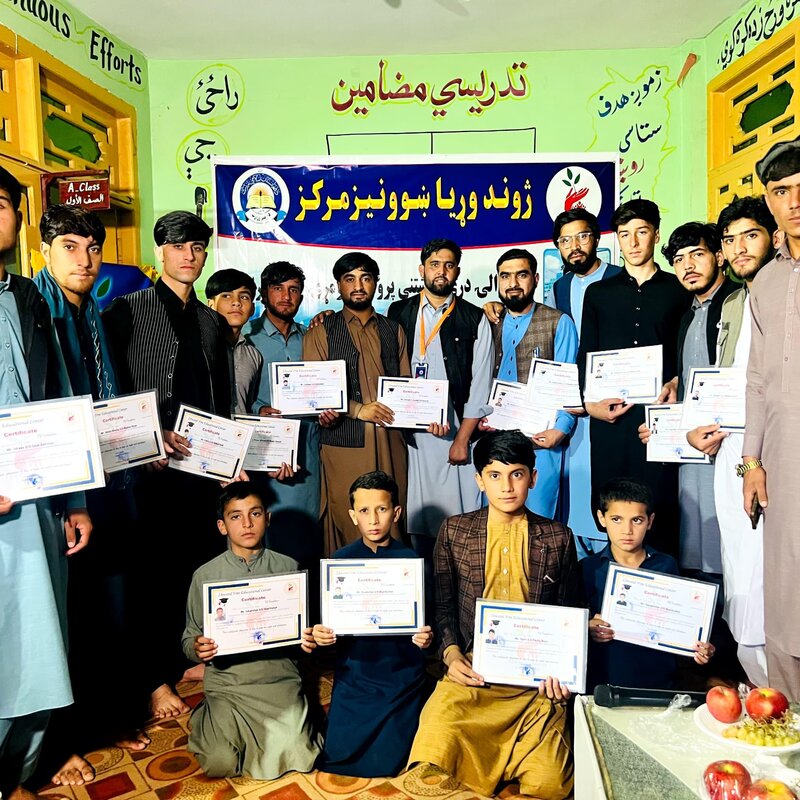 Teen boys holding certificates at a Zhwand graduation